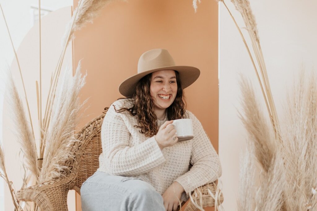 White Lady Holding A Cup of Coffee Smiling
