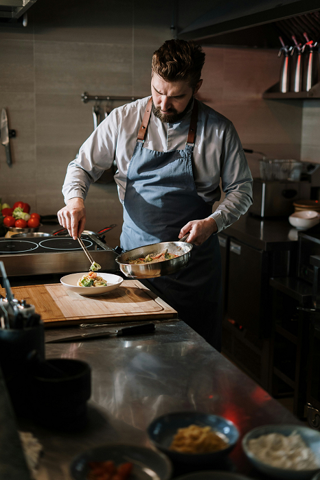 A Chef Cooking In Kitchen