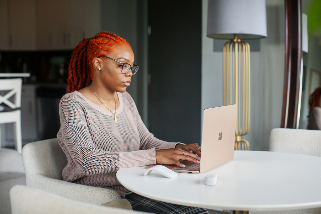 Black Lady Working On a Microsoft Surface Laptop