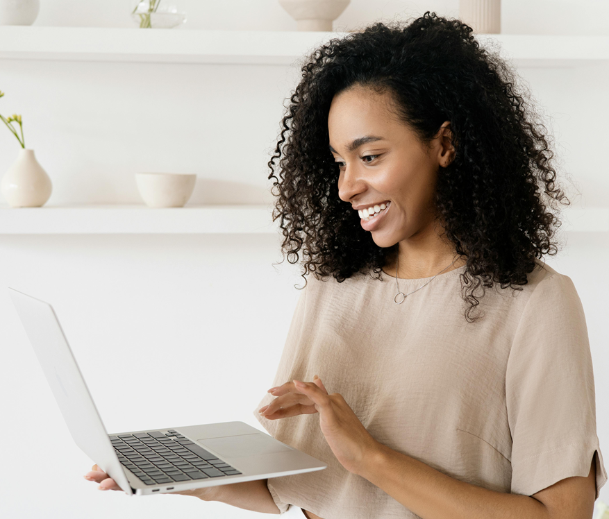Black Young Woman Smiling Working On Her Laptop Standing