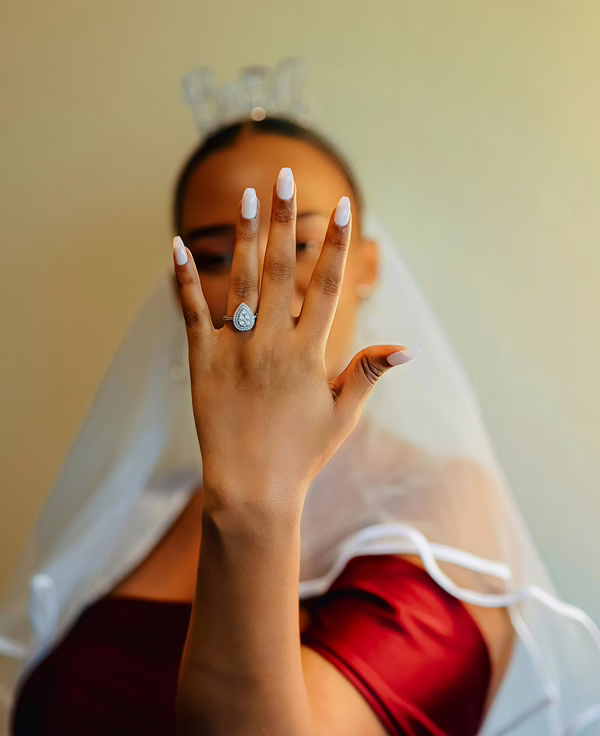 MWD - A Bride in Red Dress Showing off a Diamond Ring