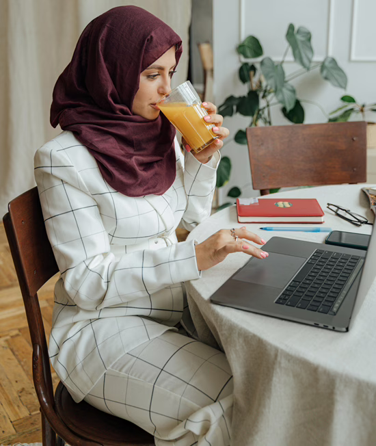 MWD - Lady Drinking Juice While On her Computer