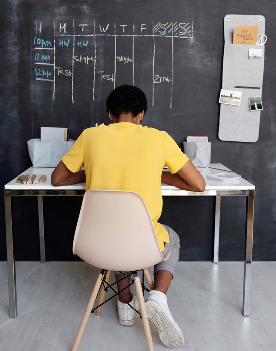 MWD - Young Man with a Yellow T-Shirt In a Classroom